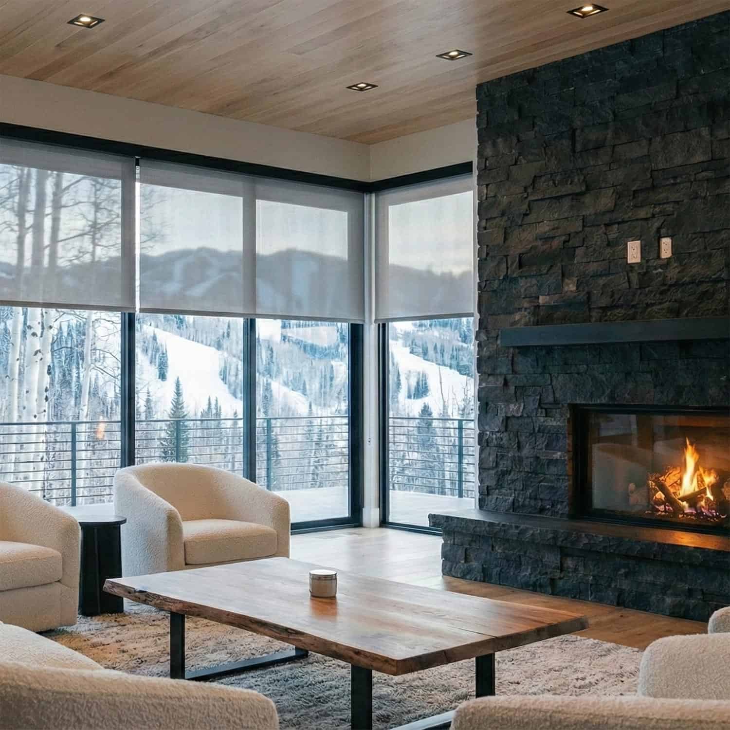 Living room with a live-edge coffee table, black stone fireplace, and motorized window shades
