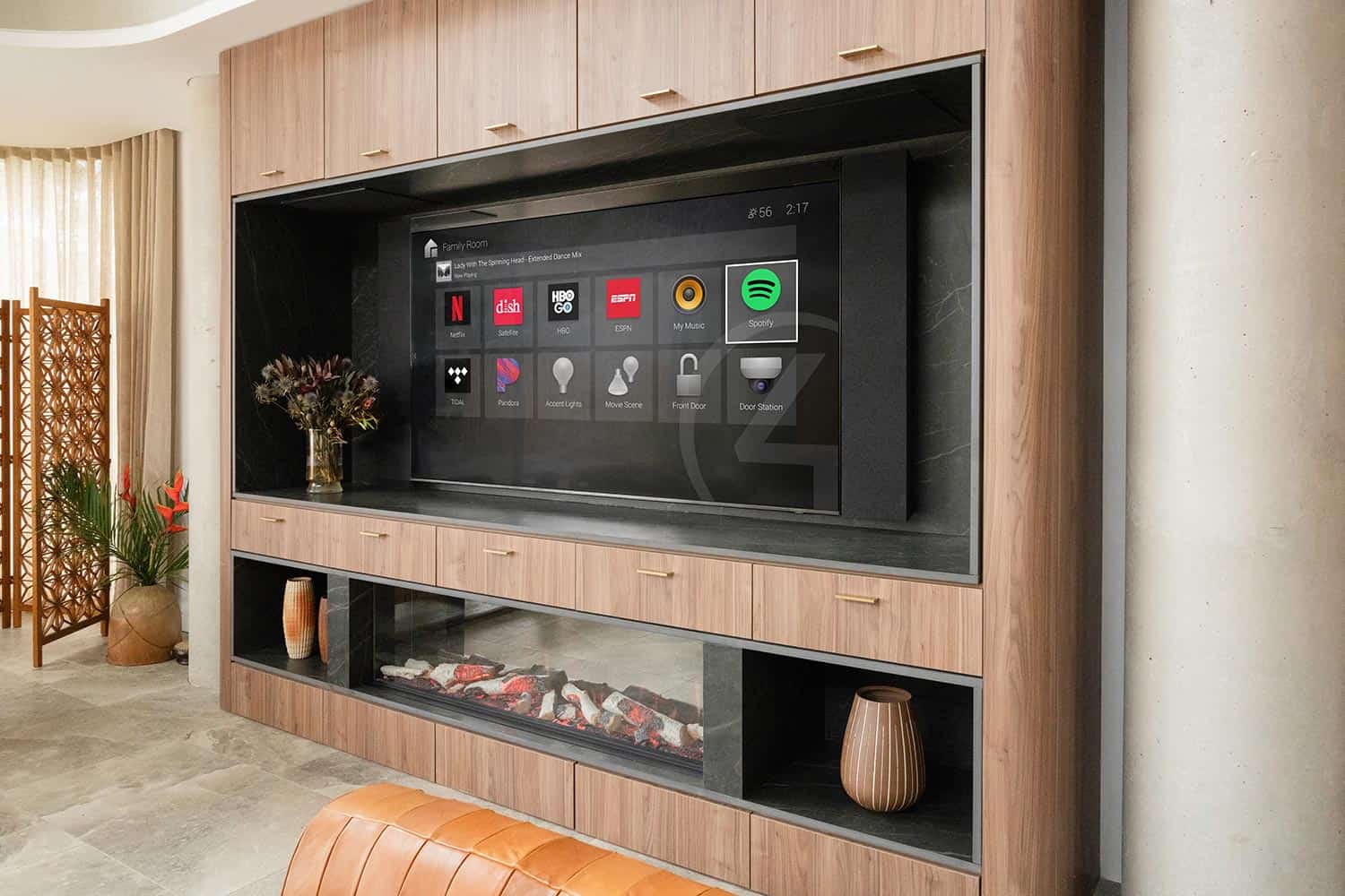 Television with smart home interface built into a custom wood wall unit above a fireplace