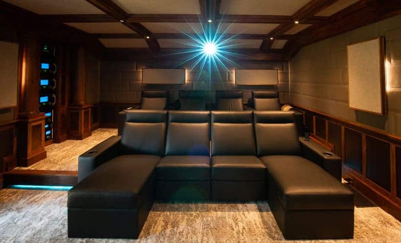 High-end home theater with leather seating and advanced audio-visual setup.