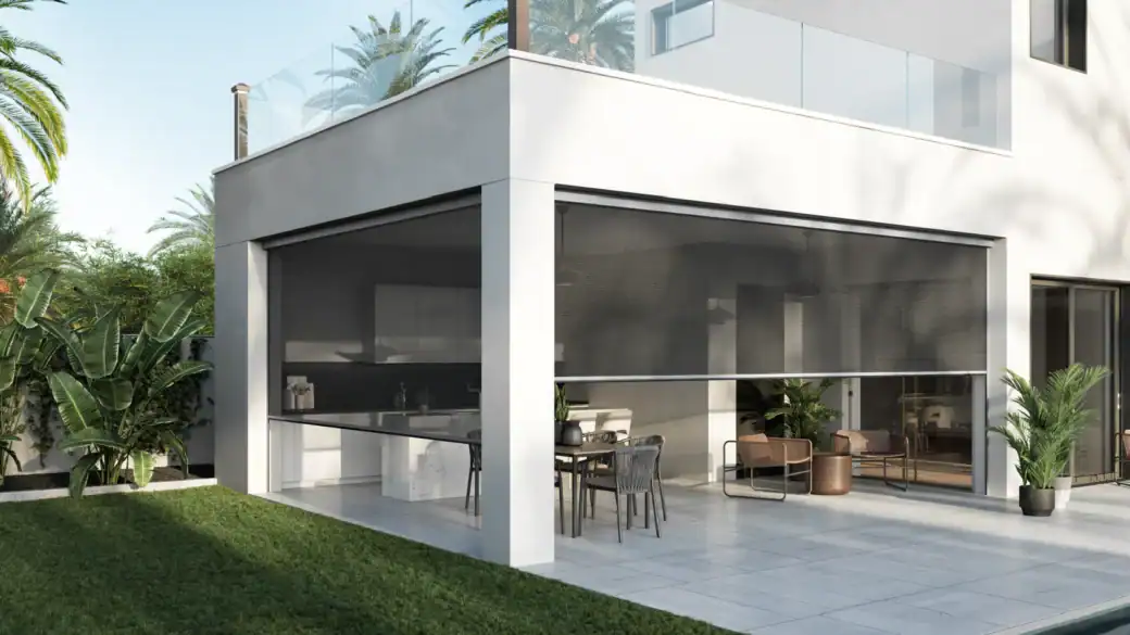 Contemporary house with large glass windows and outdoor patio area.