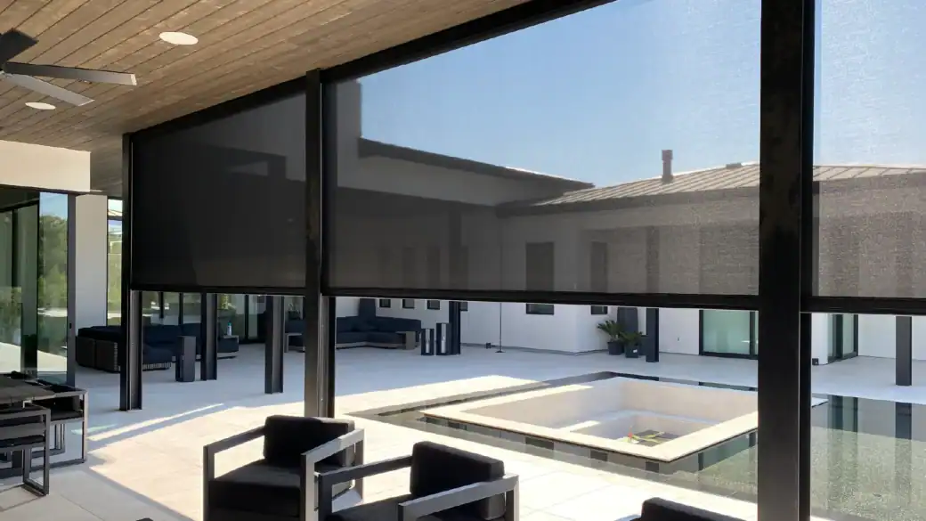 Indoor pool area with floor-to-ceiling windows and modern furniture.